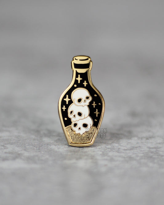 Dark Potion Enamel Pin with Skulls in Gold Plating