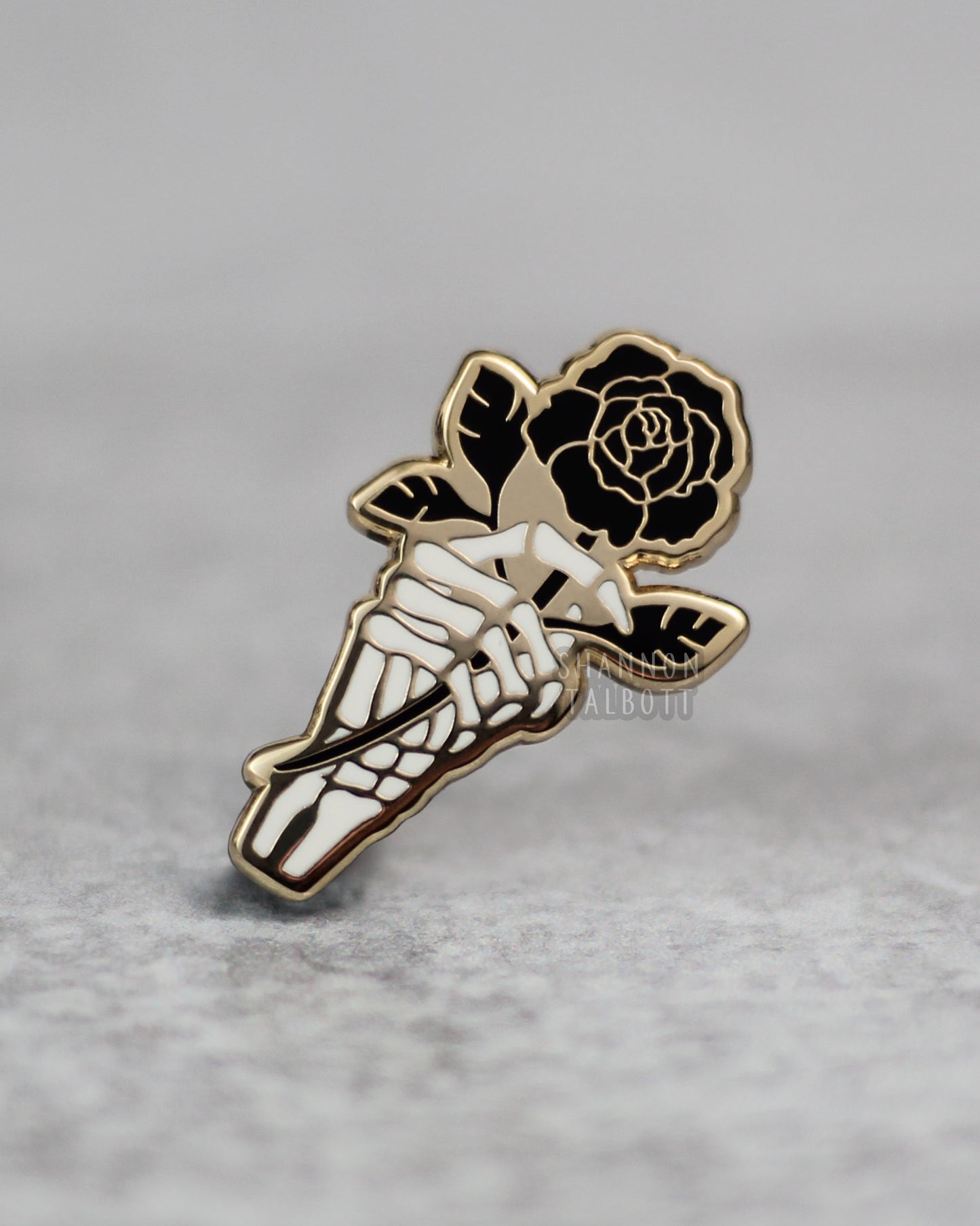 Skeleton Hand Holding Rose Enamel Pin in Gold