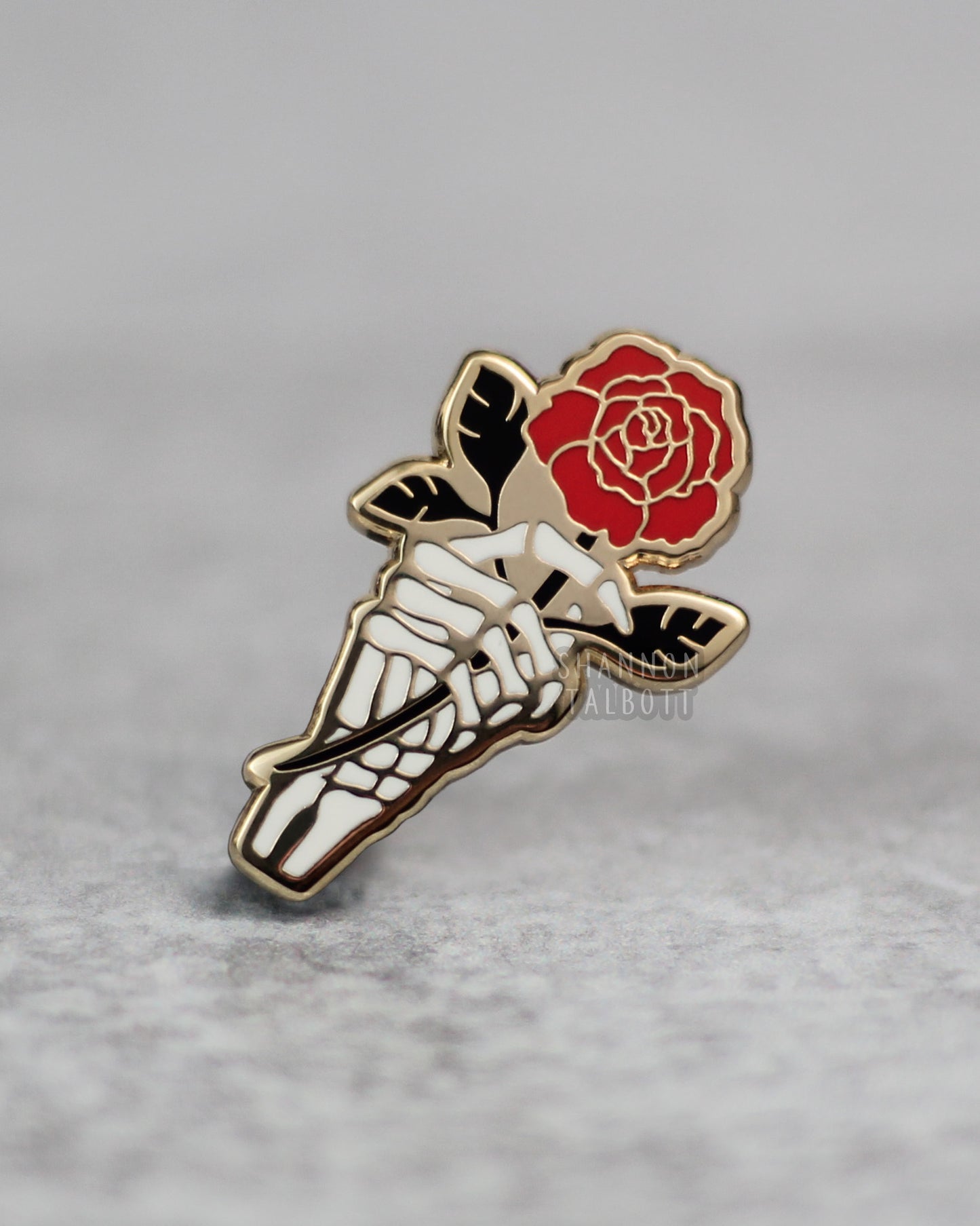 Skeleton Hand Holding Rose Enamel Pin in Gold