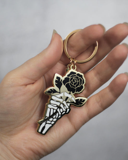 Skeleton Hand Holding Rose Enamel Keychain in Gold